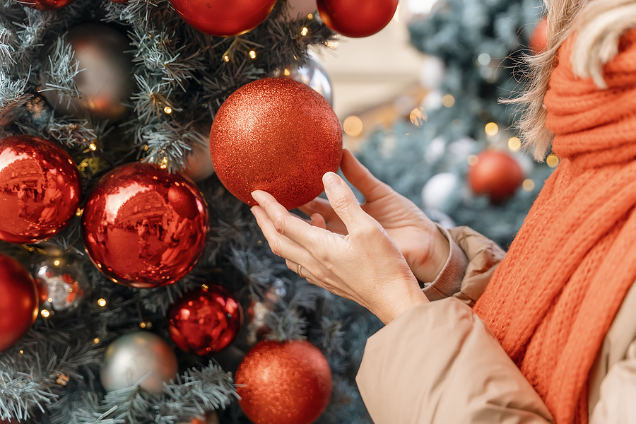 Asian Woman In Orange Scarf And Hat Walking In Christmas Market